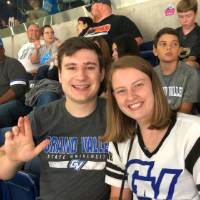 a man and woman smiling at the football game